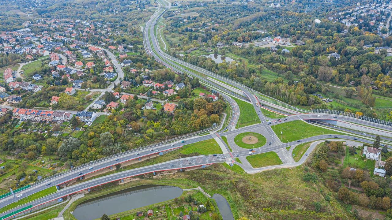 Widok z lotu ptaka na rondo, sieć ulic i pobliskie łąki